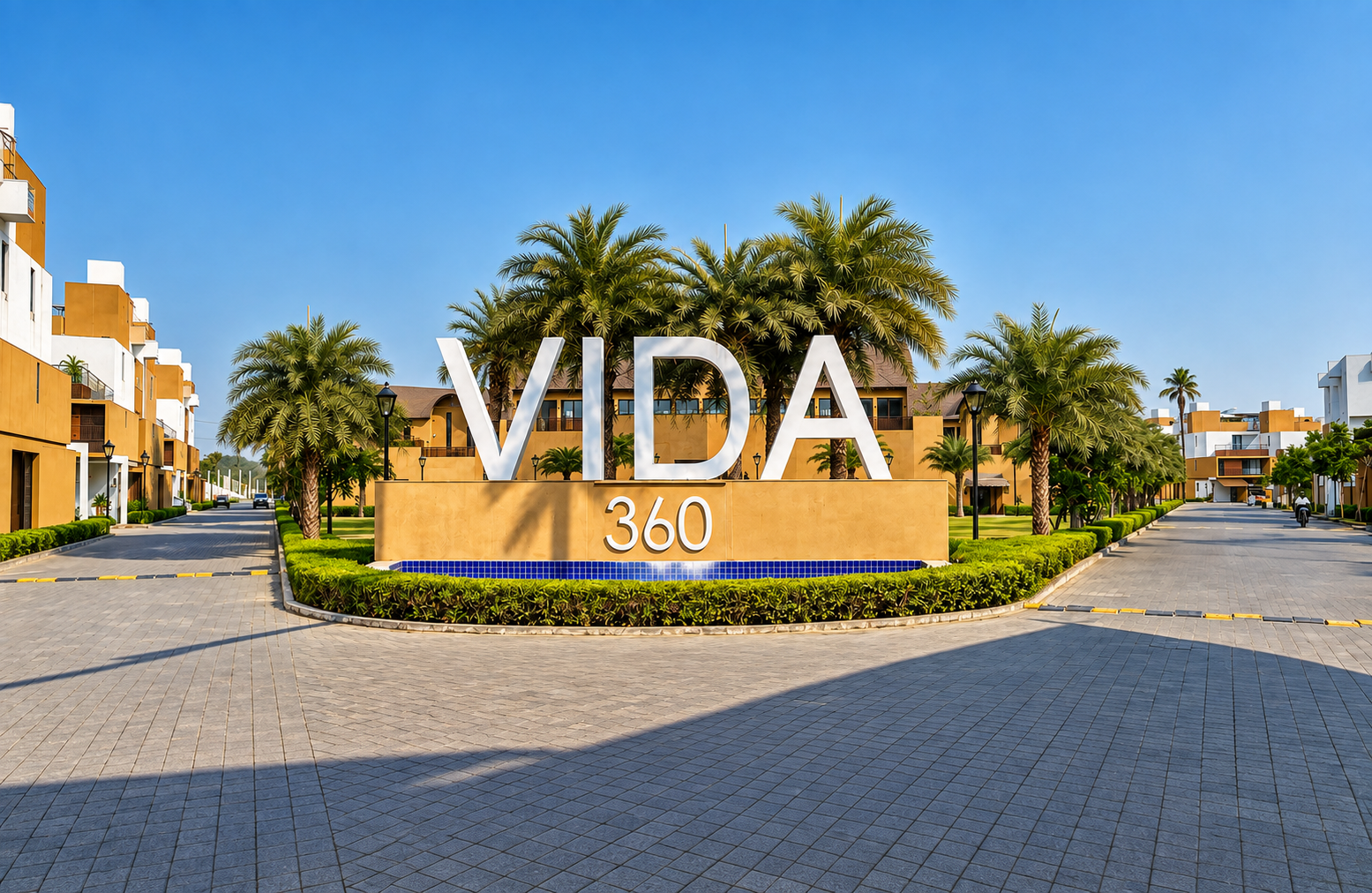 The VIDA 360 entrance, framed by palms and landscaped gardens
