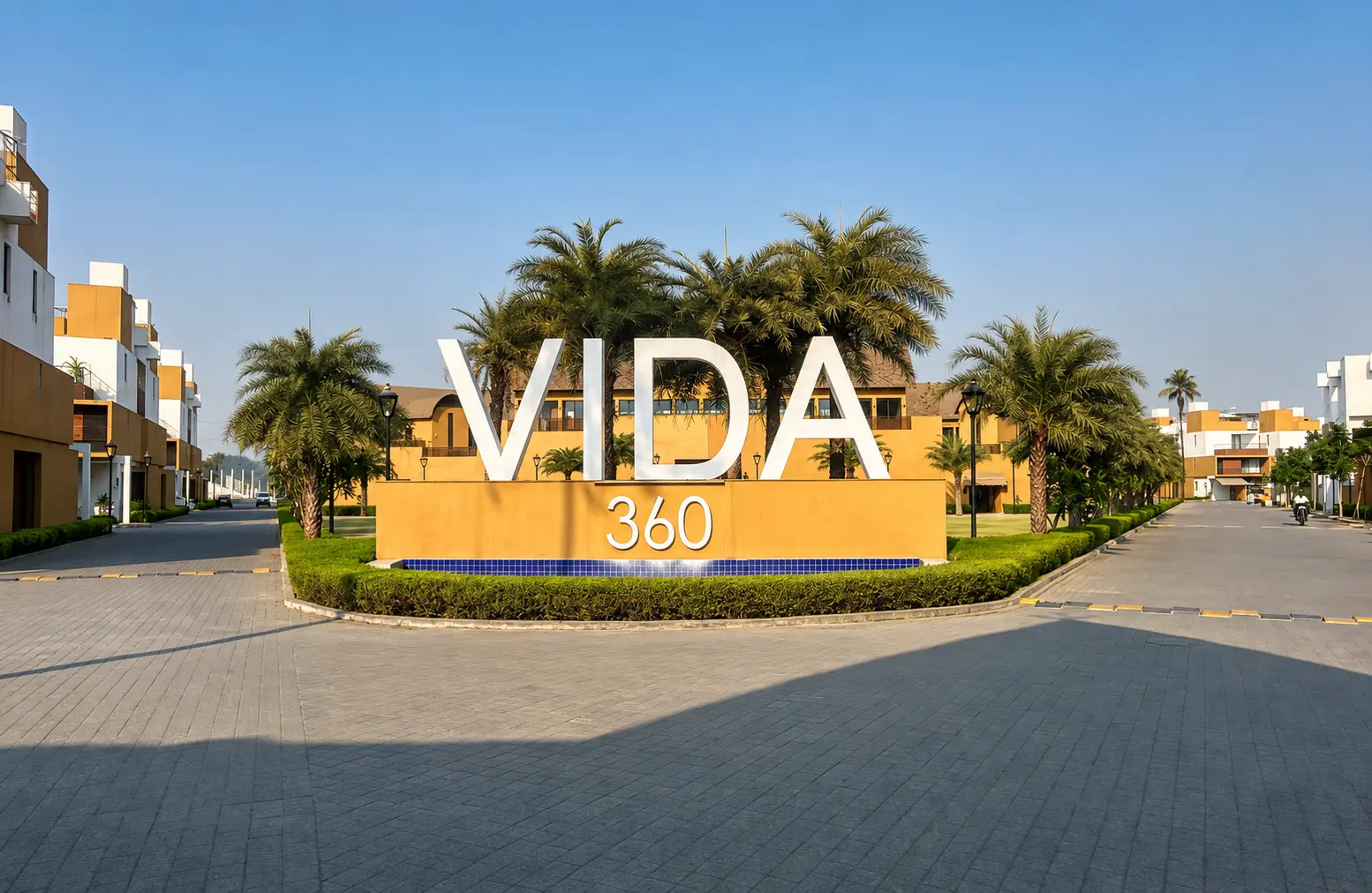 The VIDA 360 entrance, framed by palms and landscaped gardens